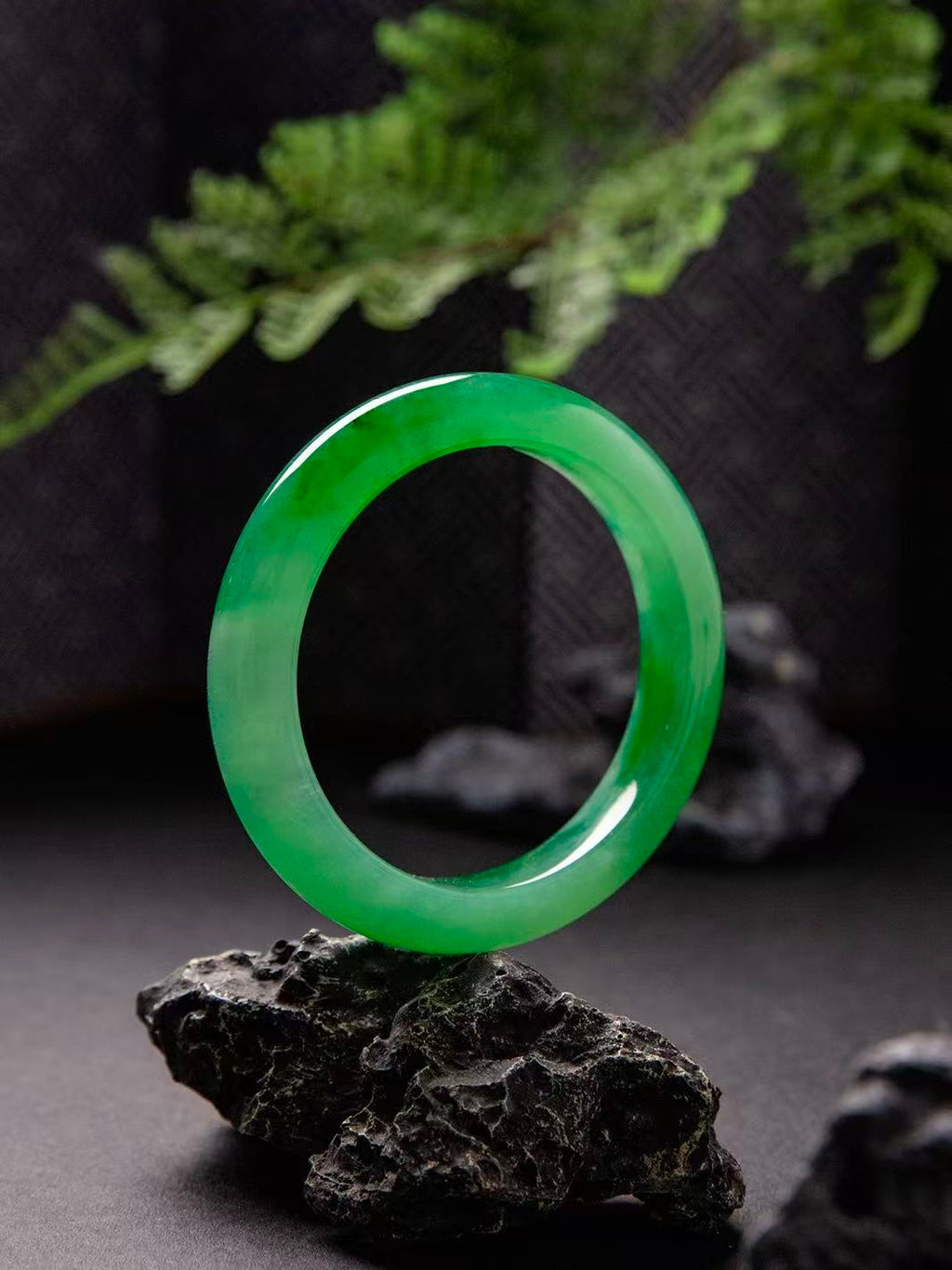 Natural Burmese jadeite bangle in vivid green with translucent texture — view 1