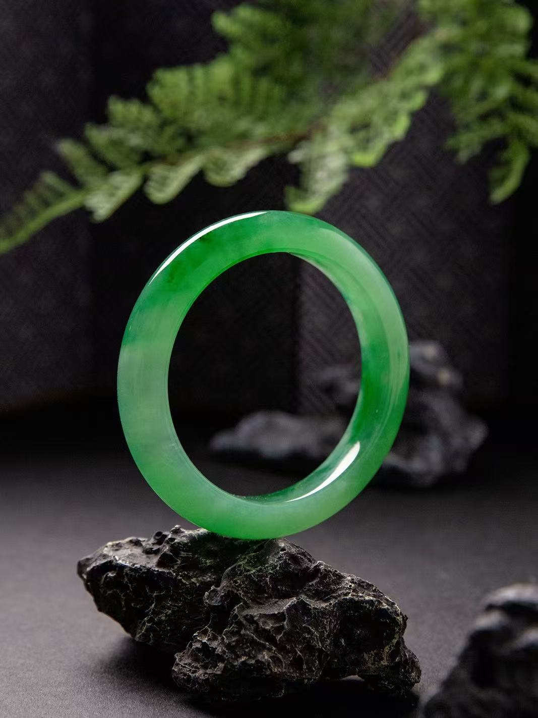 Natural Burmese jadeite bangle in vivid green with translucent texture — view 1