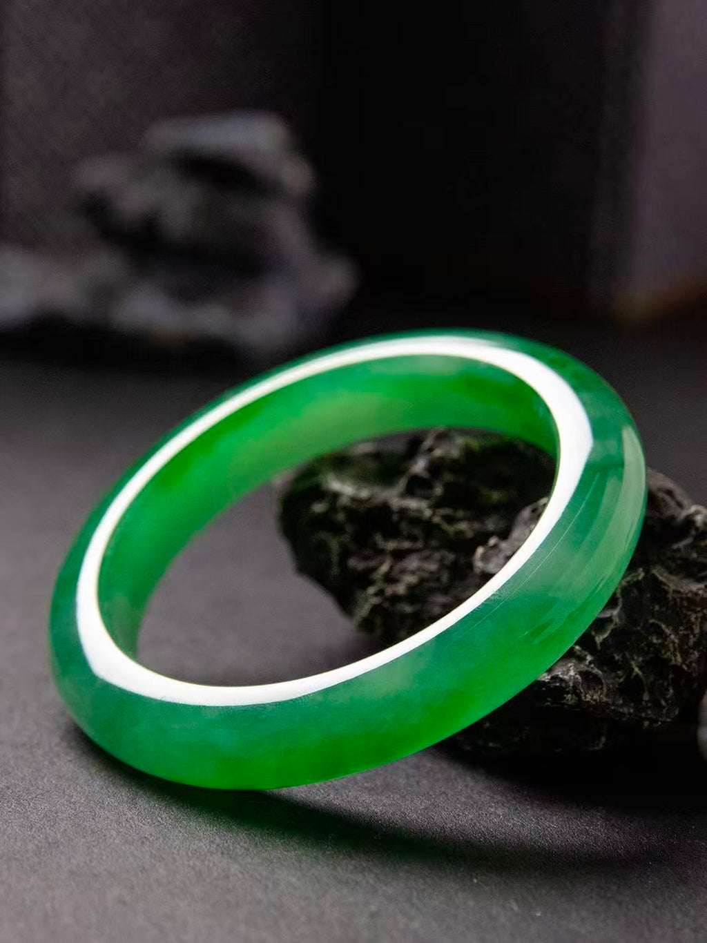 Natural Burmese jadeite bangle in vivid green with translucent texture — view 2