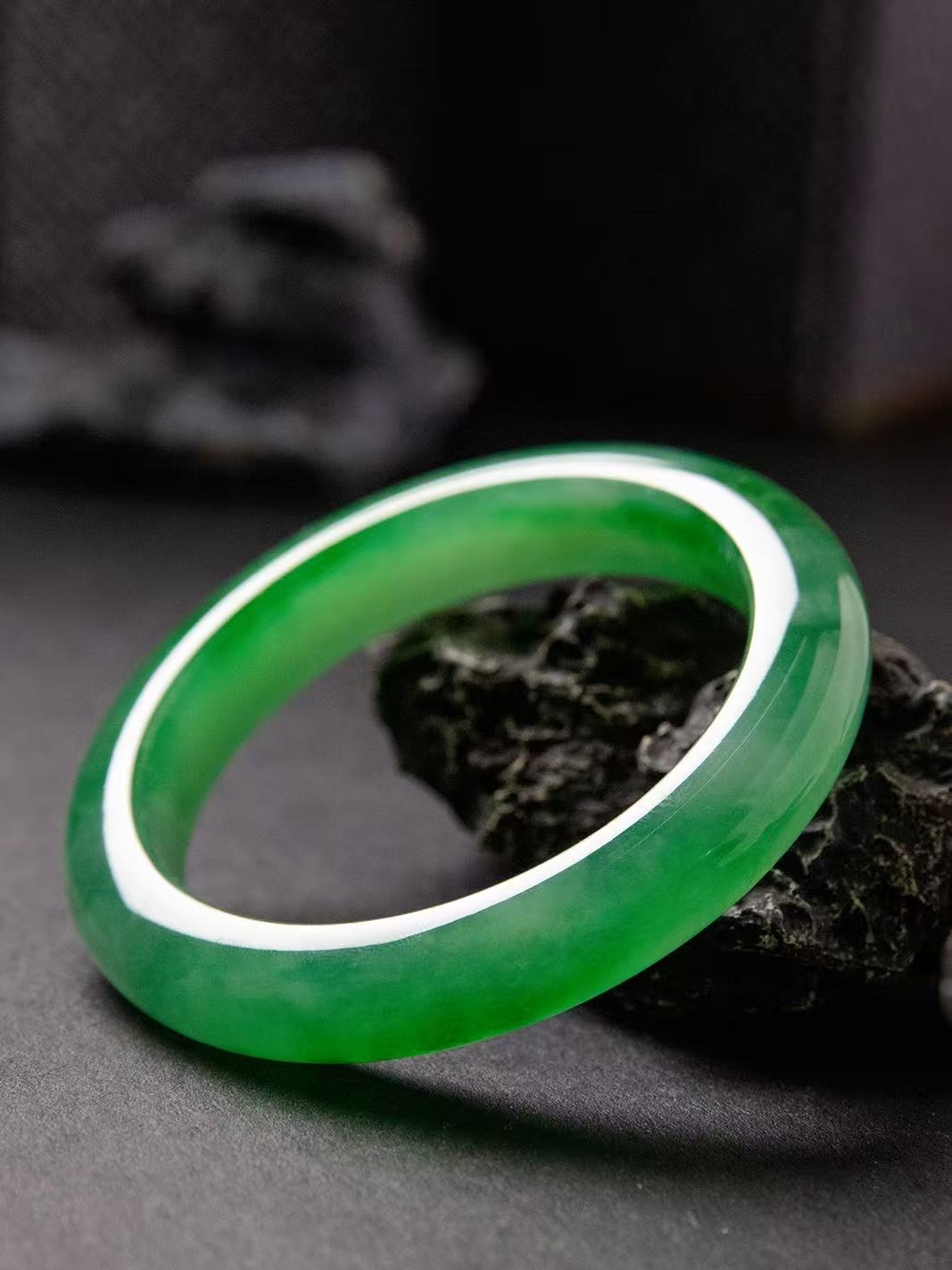 Natural Burmese jadeite bangle in vivid green with translucent texture — view 2