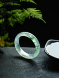 Natural Burmese jadeite bangle with floating green pattern and translucent texture — view 1