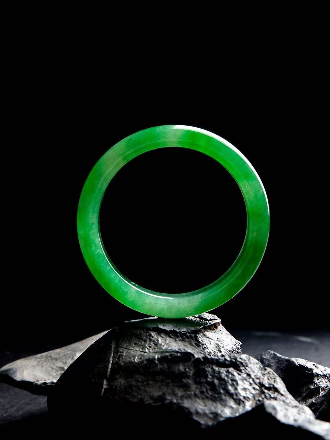 Natural Burmese jadeite bangle in vivid green with translucent texture — view 4