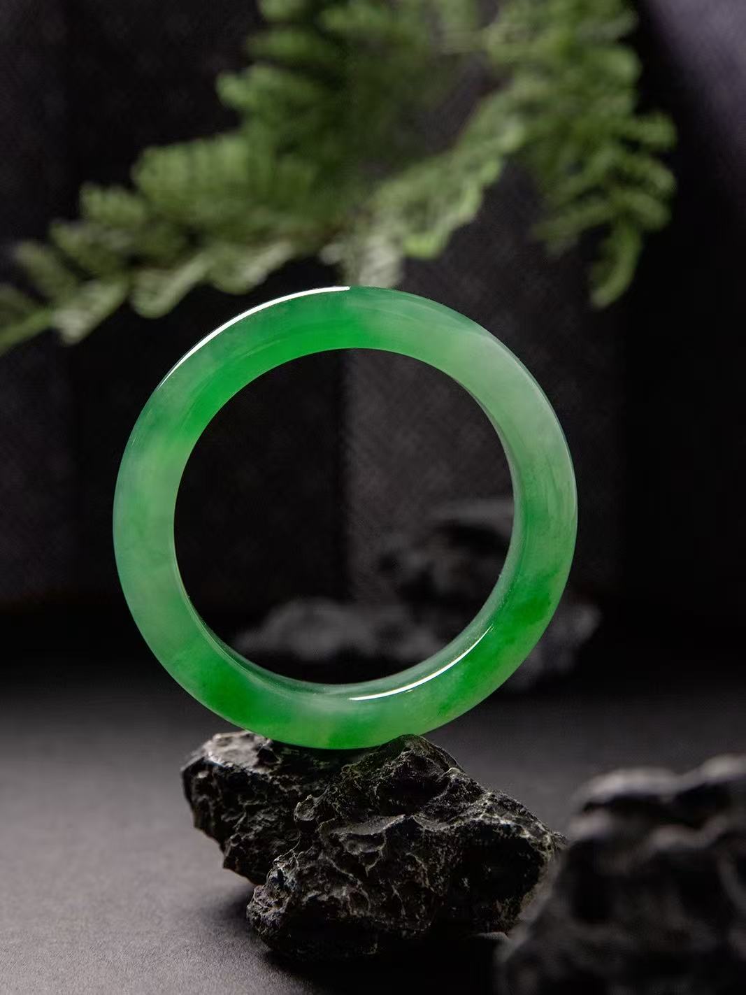 Natural Burmese jadeite bangle in vivid green with translucent texture — view 5